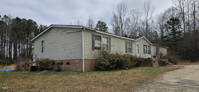 view of home's exterior featuring crawl space and aphalt driveway
