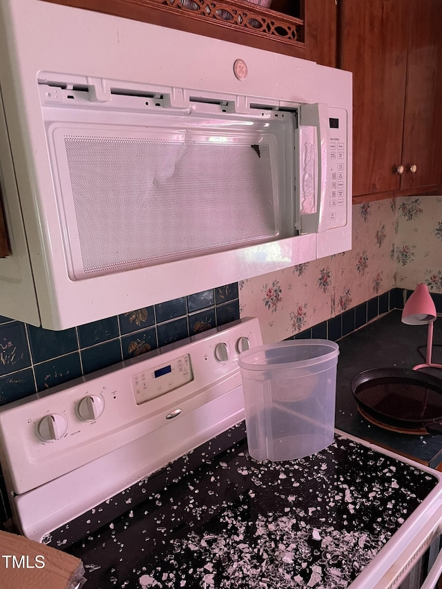 interior details with white microwave and wallpapered walls