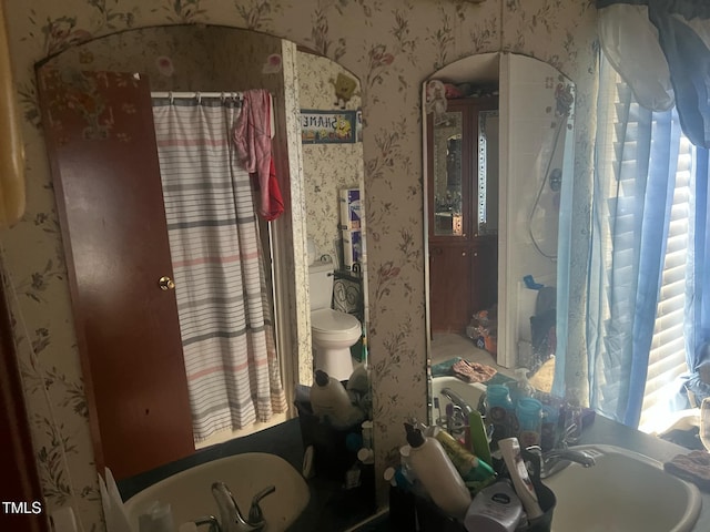 bathroom with a shower with shower curtain, wallpapered walls, toilet, and a bathtub
