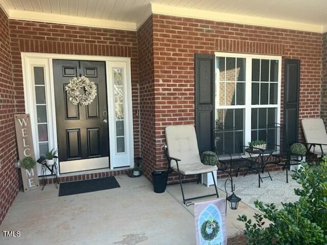 entrance to property with brick siding