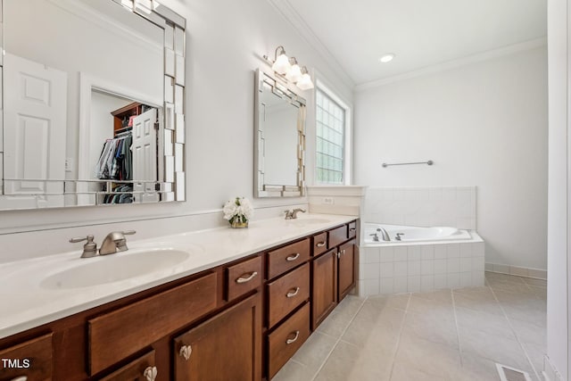 bathroom with ornamental molding, a garden tub, double vanity, tile patterned flooring, and a spacious closet