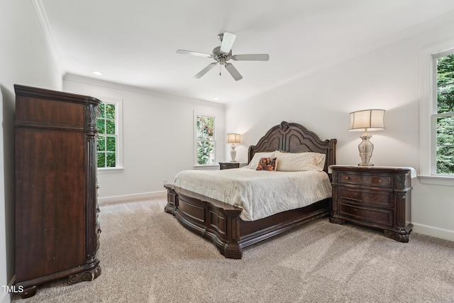 bedroom featuring light carpet, baseboards, ornamental molding, and ceiling fan