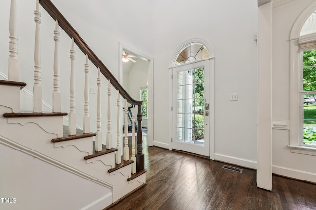 foyer entrance with stairs, hardwood / wood-style flooring, and a ceiling fan