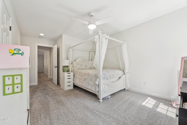 carpeted bedroom featuring baseboards and a ceiling fan