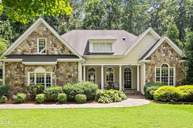 2709 Penfold Ln, Wake Forest, NC 27587 - view of front of home with stone siding, covered porch, and a front yard