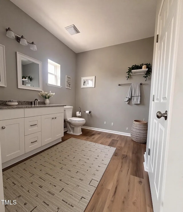 5029 Carole Dr, Wilson, NC 27893 - bathroom featuring vanity, wood finished floors, toilet, and baseboards