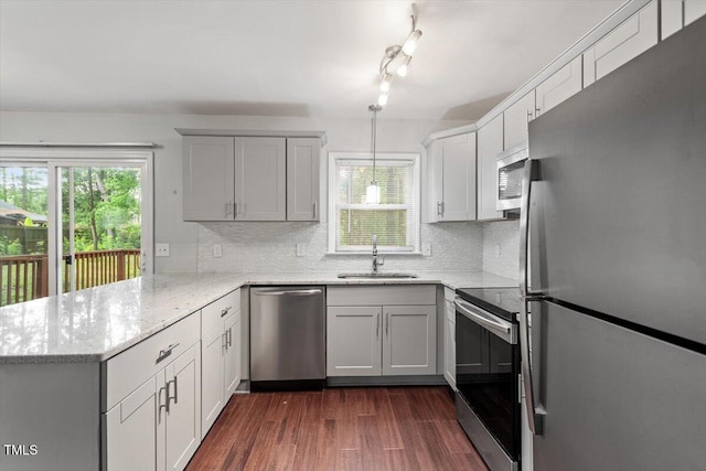 5613 Deerborn Dr, Apex, NC 27539 - kitchen with a sink, a peninsula, stainless steel appliances, and tasteful backsplash