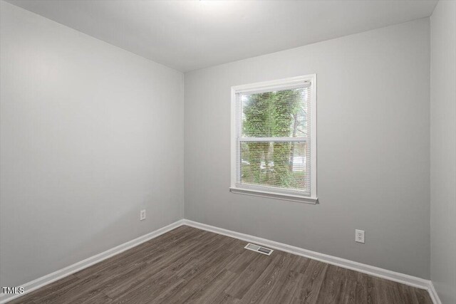 5613 Deerborn Dr, Apex, NC 27539 - unfurnished room featuring dark wood-type flooring, baseboards, and visible vents