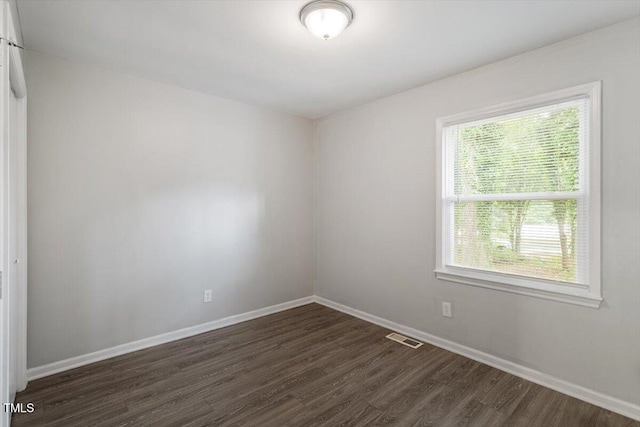 5613 Deerborn Dr, Apex, NC 27539 - unfurnished room with visible vents, dark wood-style flooring, and baseboards
