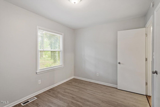 5613 Deerborn Dr, Apex, NC 27539 - empty room with visible vents, wood finished floors, and baseboards