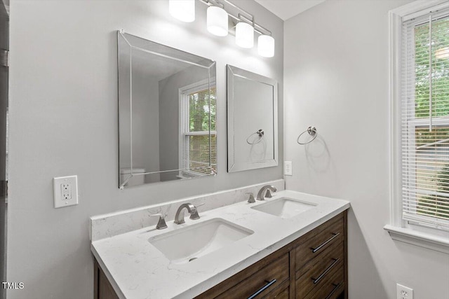 5613 Deerborn Dr, Apex, NC 27539 - full bath featuring a sink, double vanity, and a wealth of natural light
