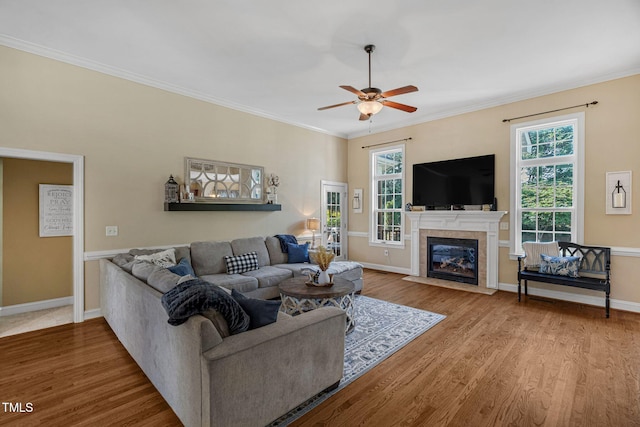 95 Live Oak Dr, Louisburg, NC 27549 - living room with a ceiling fan, wood finished floors, a tile fireplace, crown molding, and baseboards