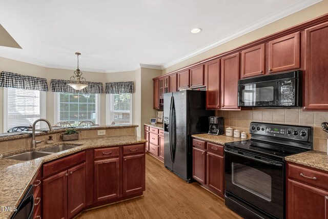 95 Live Oak Dr, Louisburg, NC 27549 - kitchen featuring black appliances, a sink, light wood finished floors, decorative light fixtures, and decorative backsplash