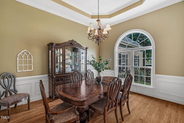 95 Live Oak Dr, Louisburg, NC 27549 - dining area featuring a chandelier, light wood-style flooring, wainscoting, ornamental molding, and a decorative wall