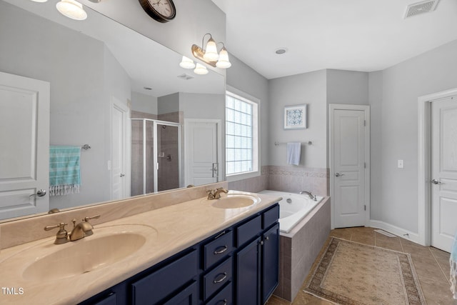 95 Live Oak Dr, Louisburg, NC 27549 - full bath featuring a garden tub, a stall shower, tile patterned flooring, and double vanity