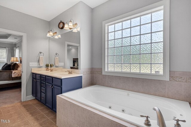 95 Live Oak Dr, Louisburg, NC 27549 - ensuite bathroom with double vanity, a tub with jets, and tile patterned floors