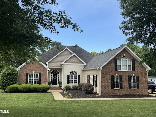 95 Live Oak Dr, Louisburg, NC 27549 - view of front of property with a front lawn, brick siding, and a shingled roof