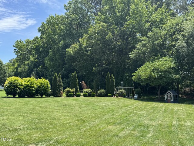 95 Live Oak Dr, Louisburg, NC 27549 - view of green lawn featuring an outbuilding and a shed