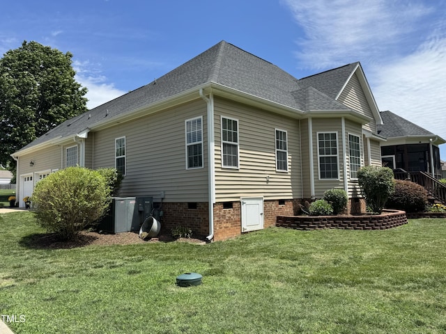 95 Live Oak Dr, Louisburg, NC 27549 - view of side of property featuring crawl space, a lawn, a sunroom, an attached garage, and roof with shingles