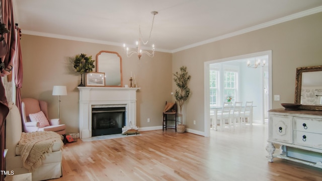 living area featuring an inviting chandelier, a premium fireplace, baseboards, wood finished floors, and ornamental molding