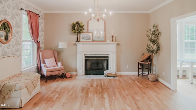 sitting room with a fireplace with flush hearth, crown molding, wood finished floors, baseboards, and an inviting chandelier