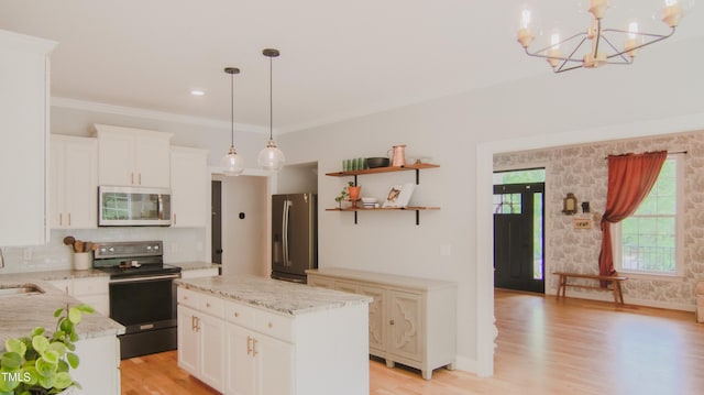 kitchen with white cabinets, open shelves, a notable chandelier, light wood-style flooring, and stainless steel appliances