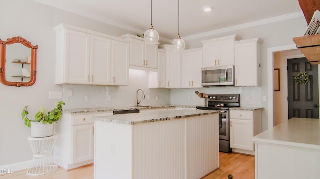 kitchen featuring a sink, decorative backsplash, white cabinetry, and stainless steel appliances