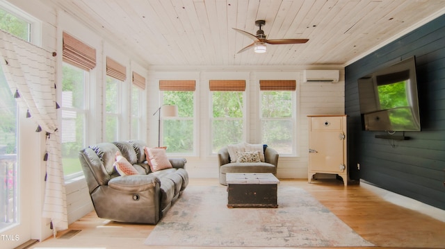 sunroom featuring wooden walls, wooden ceiling, wood finished floors, and a wall mounted air conditioner