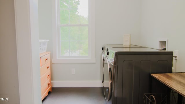 washroom with baseboards, plenty of natural light, laundry area, and independent washer and dryer