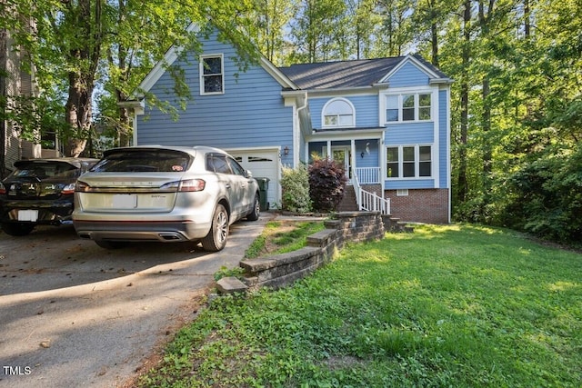 traditional-style house with a garage, a front yard, and aphalt driveway