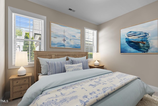 bedroom with baseboards, carpet, and visible vents