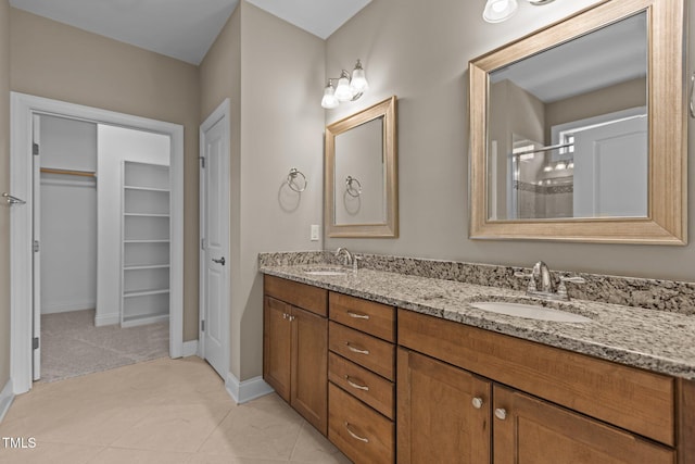 bathroom with baseboards, a sink, and a shower