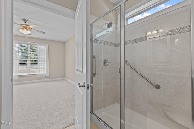 full bath featuring ceiling fan, baseboards, and a stall shower