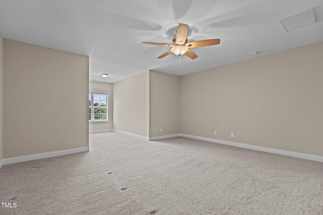 unfurnished room with baseboards, carpet, a ceiling fan, and visible vents