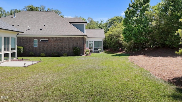view of yard featuring a sunroom and a patio area