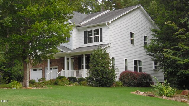 106 N Duelling Oaks Dr, Chapel Hill, NC 27517 - view of front of home with covered porch, a front lawn, and an attached garage
