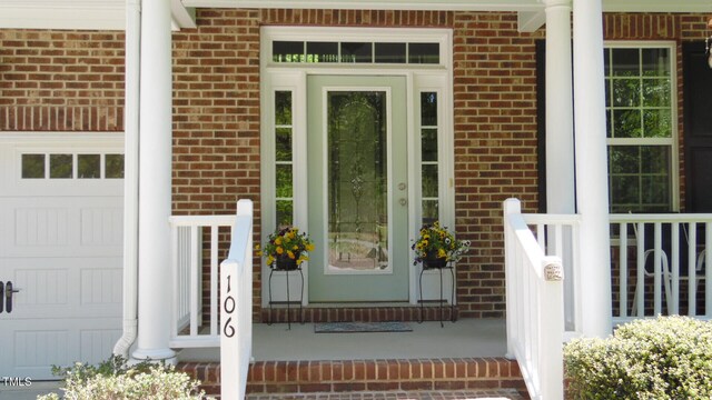 106 N Duelling Oaks Dr, Chapel Hill, NC 27517 - view of exterior entry featuring brick siding and an attached garage