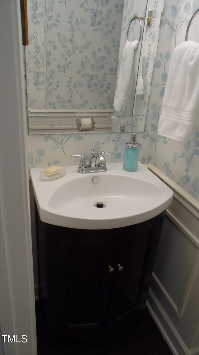 106 N Duelling Oaks Dr, Chapel Hill, NC 27517 - bathroom with wallpapered walls, vanity, and a wainscoted wall