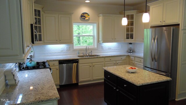 106 N Duelling Oaks Dr, Chapel Hill, NC 27517 - kitchen featuring appliances with stainless steel finishes, a sink, backsplash, light stone countertops, and ornamental molding