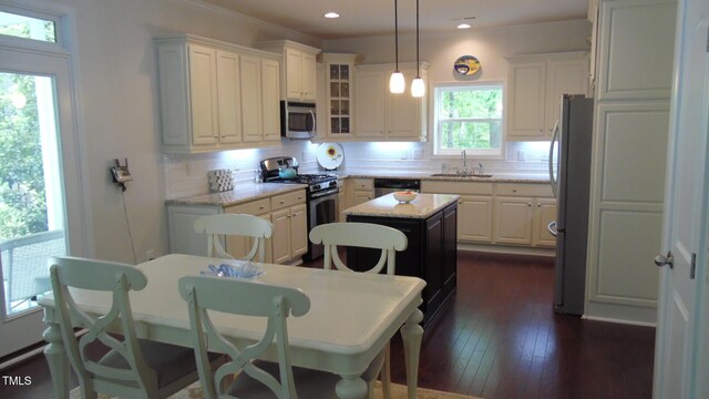 106 N Duelling Oaks Dr, Chapel Hill, NC 27517 - kitchen featuring stainless steel appliances, a sink, decorative backsplash, a center island, and white cabinets