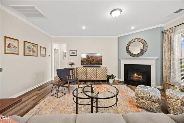 1533 Santa Lucia St, Wake Forest, NC 27587 - living area featuring wood finished floors, ornamental molding, baseboards, a fireplace with flush hearth, and recessed lighting