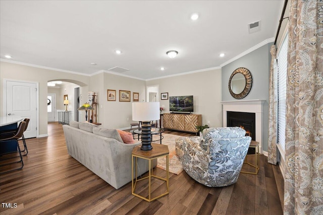 1533 Santa Lucia St, Wake Forest, NC 27587 - living room featuring wood finished floors, arched walkways, a lit fireplace, recessed lighting, and ornamental molding