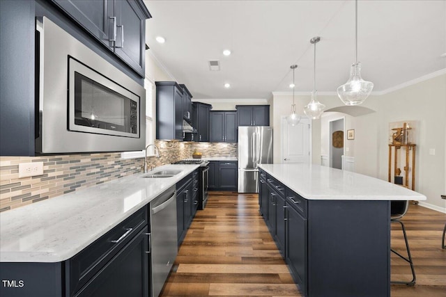 1533 Santa Lucia St, Wake Forest, NC 27587 - kitchen with stainless steel appliances, a sink, crown molding, dark wood finished floors, and a kitchen breakfast bar
