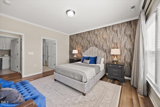1533 Santa Lucia St, Wake Forest, NC 27587 - bedroom featuring an accent wall, ornamental molding, wood finished floors, and baseboards