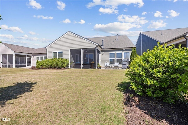 1533 Santa Lucia St, Wake Forest, NC 27587 - rear view of property featuring a sunroom, a lawn, and a shingled roof