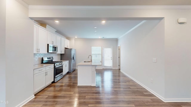 1314 Rosepine Dr, Cary, NC 27519 - kitchen featuring appliances with stainless steel finishes, a sink, an island with sink, wood finished floors, and white cabinets