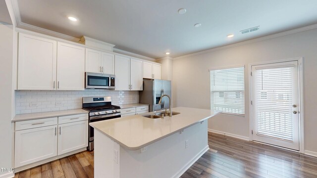 1314 Rosepine Dr, Cary, NC 27519 - kitchen featuring stainless steel appliances, a sink, tasteful backsplash, crown molding, and a kitchen island with sink