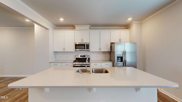 1314 Rosepine Dr, Cary, NC 27519 - kitchen with stainless steel appliances, a sink, light wood finished floors, crown molding, and tasteful backsplash