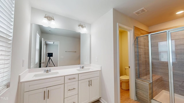 1314 Rosepine Dr, Cary, NC 27519 - bathroom featuring a stall shower, healthy amount of natural light, double vanity, and toilet