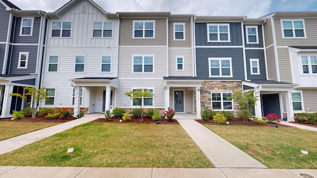 1314 Rosepine Dr, Cary, NC 27519 - view of property featuring board and batten siding, stone siding, and a front yard